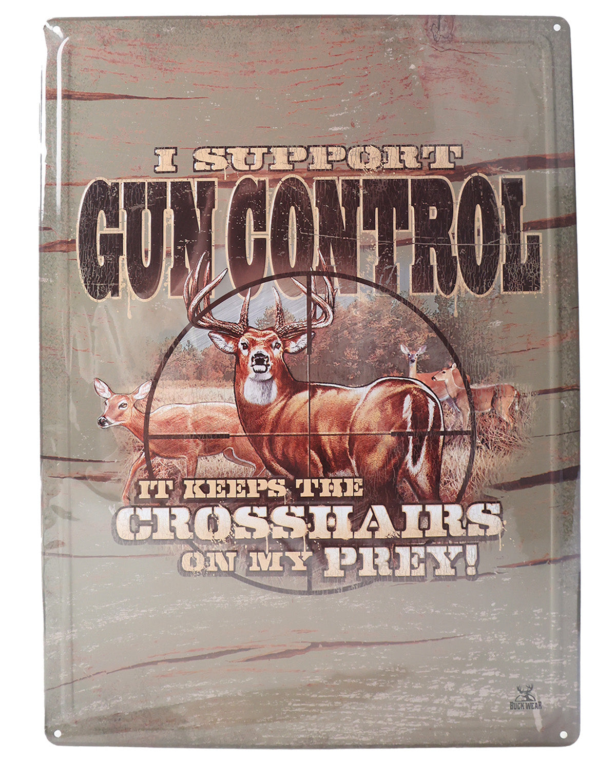Metal sign with a deer and text about gun control on a wooden background