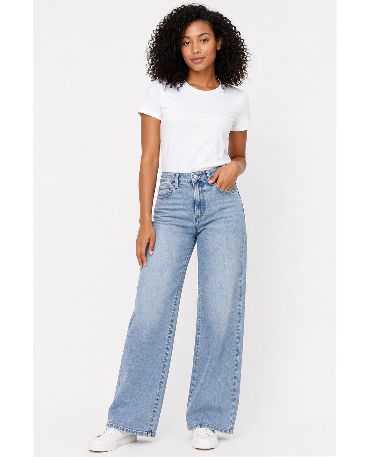 Woman wearing light blue jeans and a white t-shirt on a white background