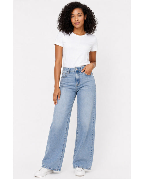 Woman wearing light blue jeans and a white t-shirt on a white background