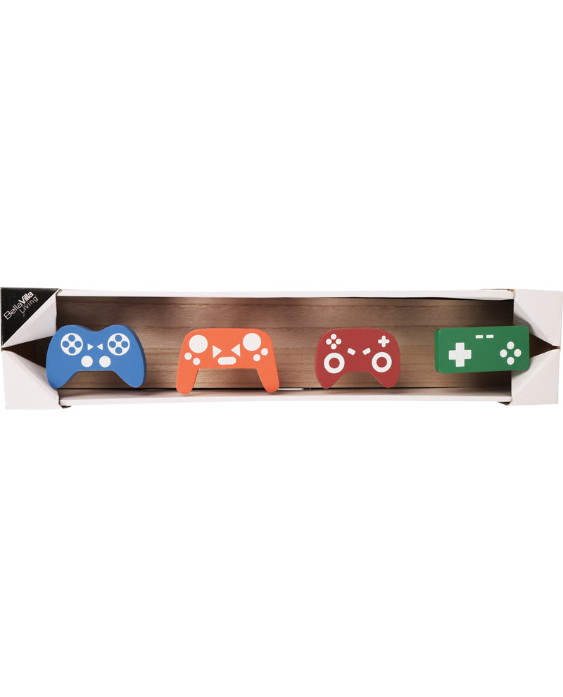 Four colorful gaming controller-shaped coasters on a wooden board with a white background.