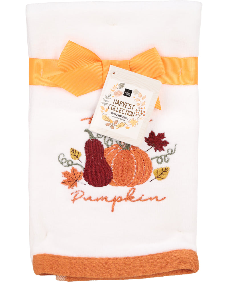 White towel with orange border and autumn-themed design featuring pumpkins and leaves, labeled 'Harvest Collection'.