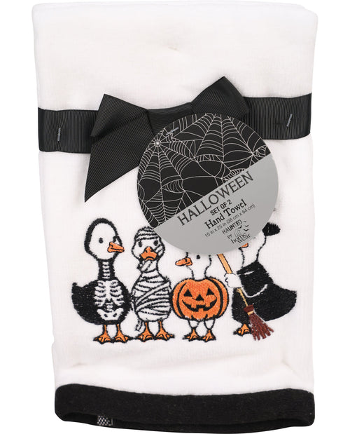 Set of two Halloween-themed hand towels with cartoon ghosts, skeleton, and pumpkin design on a white background.
