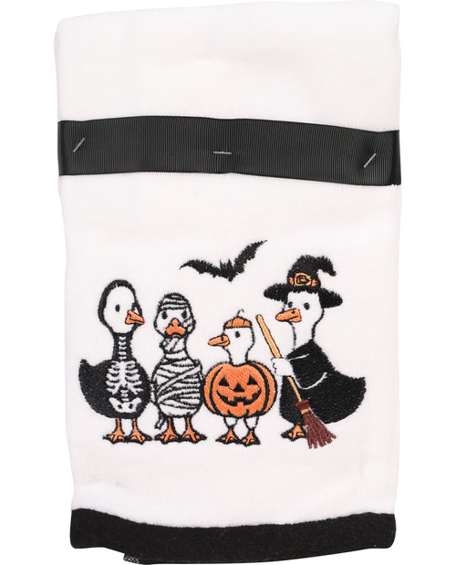 Halloween-themed towel with cartoon ducks dressed in costumes on a white background
