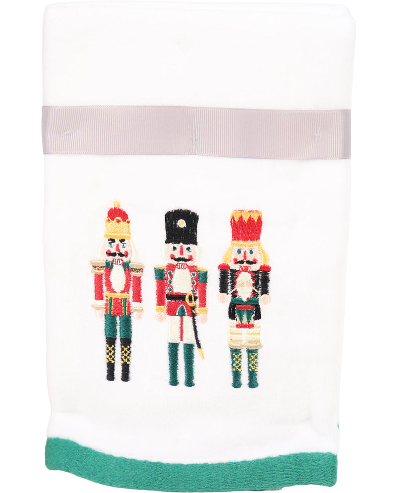 Towel with embroidered nutcracker design on a white background