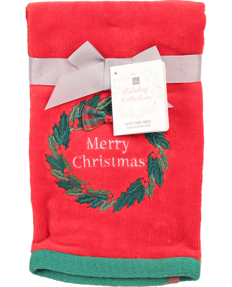 Red towel with green holly wreath and 'Merry Christmas' text, tied with a gray ribbon on a white background.