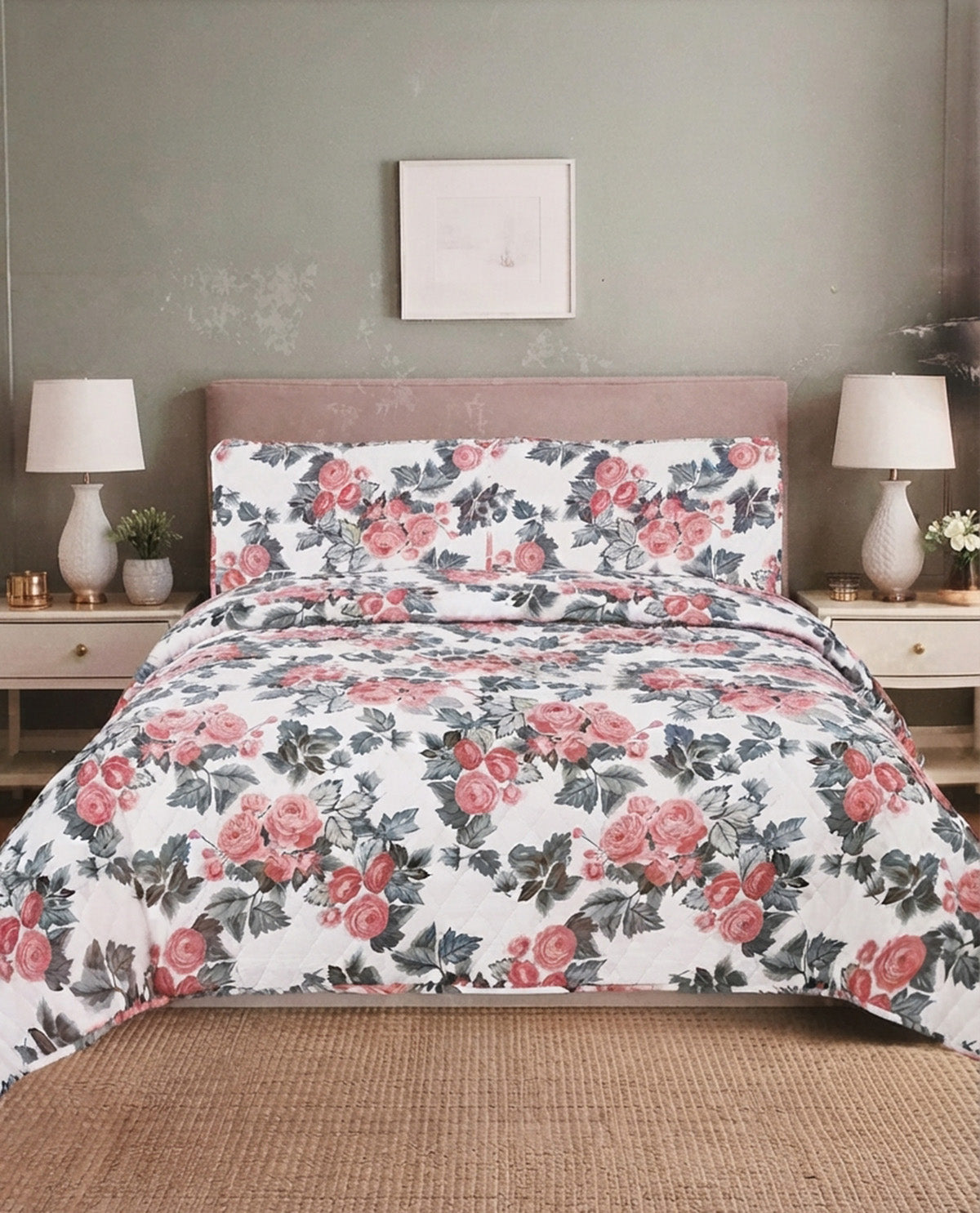 A floral bedding set featuring a duvet cover and two matching pillowcases with a pink rose and green leaf pattern on a white background, styled on a bed in a bedroom setting.