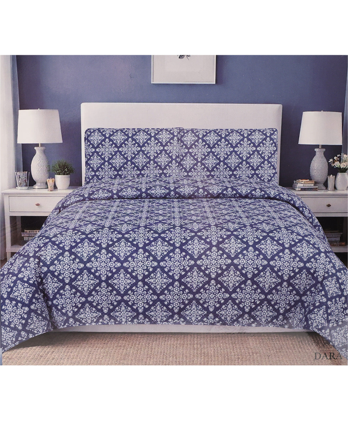 A bed dressed in a navy blue and white geometric patterned comforter set with matching pillow shams, styled in a bedroom with a white headboard, white nightstands, and blue walls.