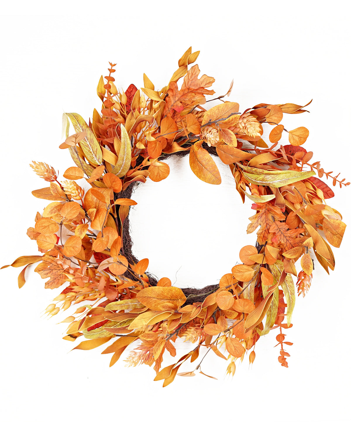 An autumn-themed artificial wreath with orange, brown, and gold leaves on a white background.