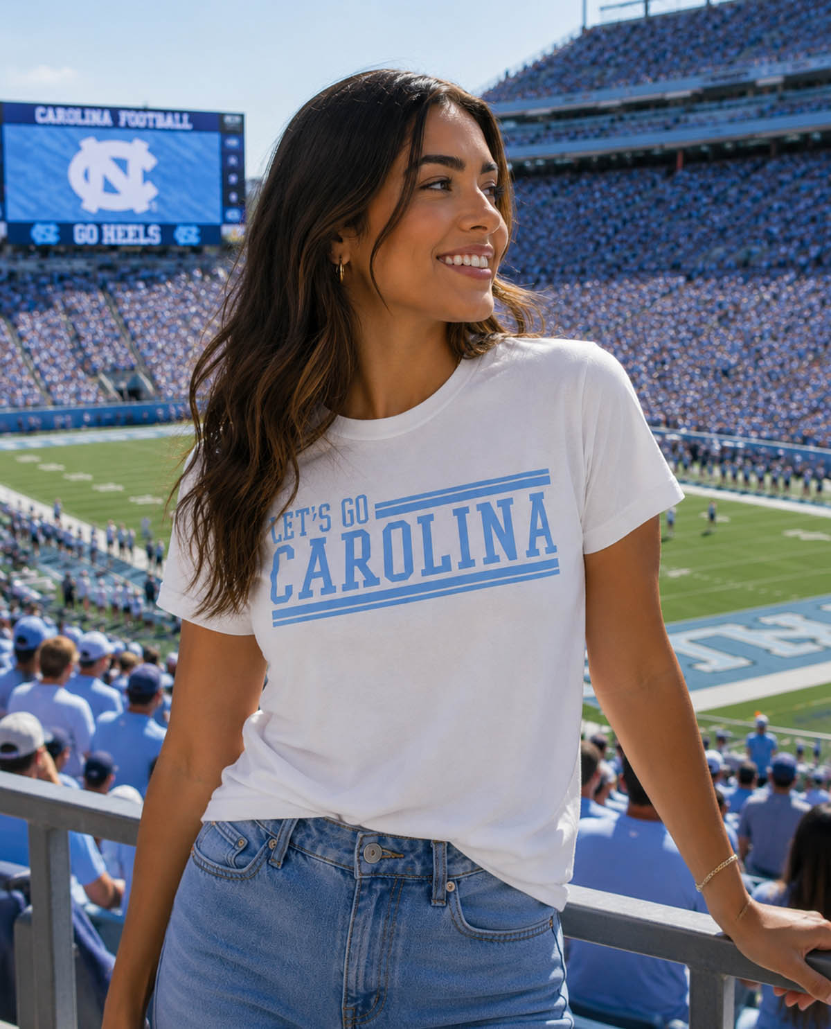 Woman wearing a 'Let's Go Carolina' t-shirt at a football stadium.