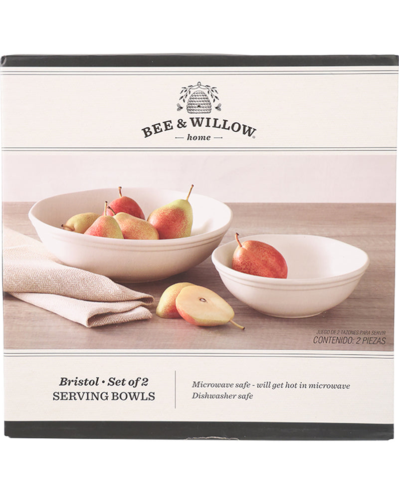 Bee & Willow home Bristol set of 2 serving bowls in their retail packaging box. The packaging features a photo of the two white ceramic bowls containing pears on a wooden table, with product details listed below.