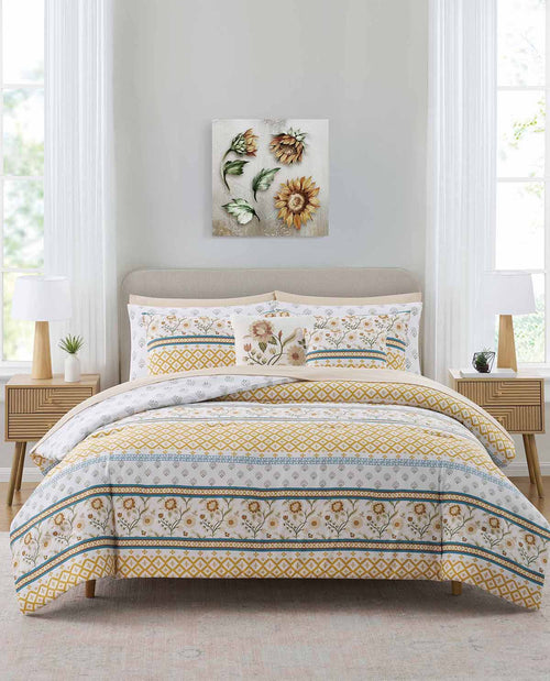 Bedroom with floral bedding set and wall art on a light gray wall.