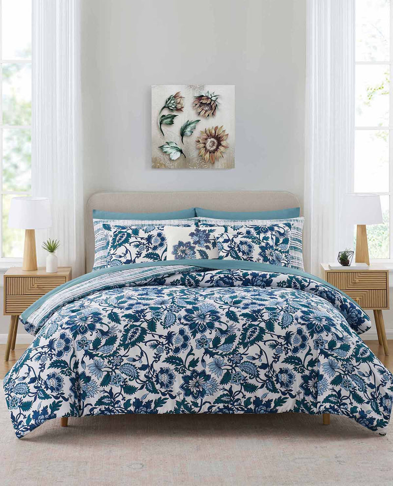 Bedroom with floral bedding set and decorative wall art.