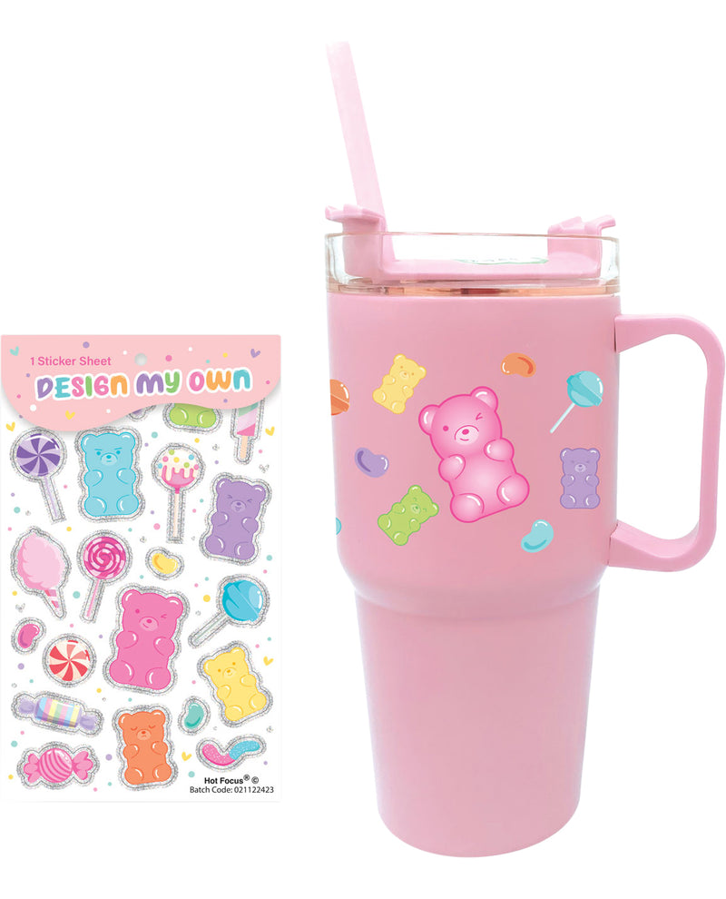 Pink tumbler with handle and straw, featuring stickers of a teddy bear and candy-themed designs, next to a sheet of 'Design My Own' stickers.