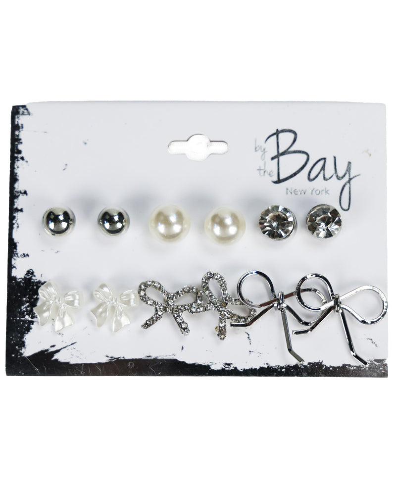 A 10-piece stud earrings set by the Bay New York on a white display card. The set includes five pearl and crystal stud earrings on the top row, and five silver and white crystal bow stud earrings on the bottom row.