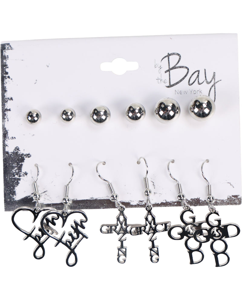 A set of silver-toned earrings displayed on a white branded card backing. The top row shows five small round stud earrings, and the bottom row shows five dangling hook earrings with script and monogram designs including 'love', 'grace', 'faith', 'good', and 'God'.