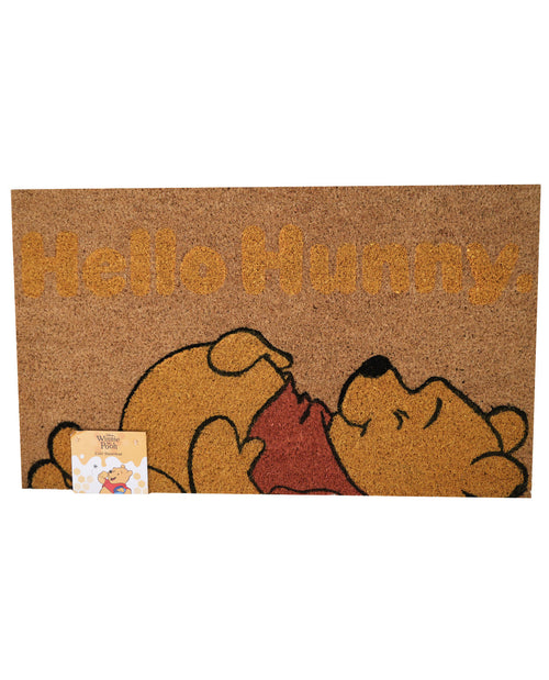 A coir doormat featuring Winnie the Pooh and the text 'Hello Hunny' in tan, with a small product tag attached in the lower-left corner, shown against a plain white background.