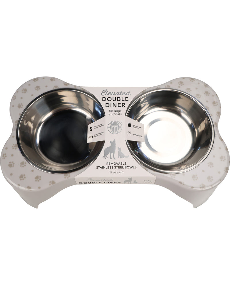 A bone-shaped double pet feeder and waterer with two stainless steel bowls, shown on a plain white background. The feeder base is white with a subtle paw print pattern, and the bowls are reflective stainless steel.