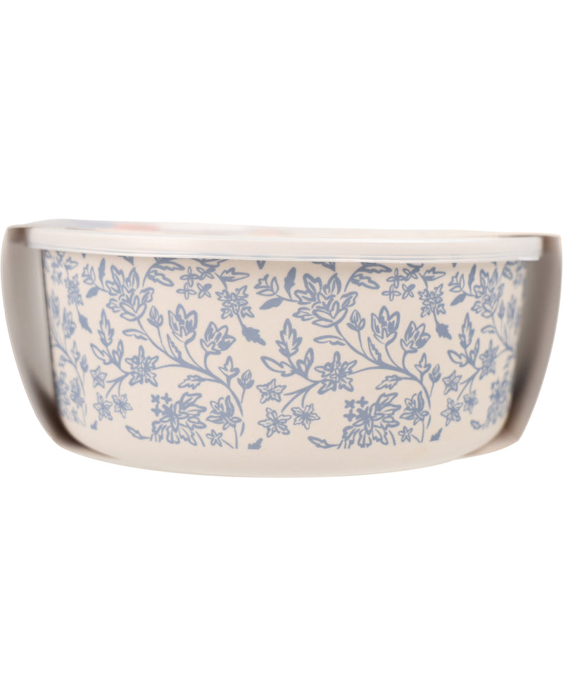 A ceramic casserole dish with a blue floral vine pattern on an off-white background, shown from a side angle against a white background.
