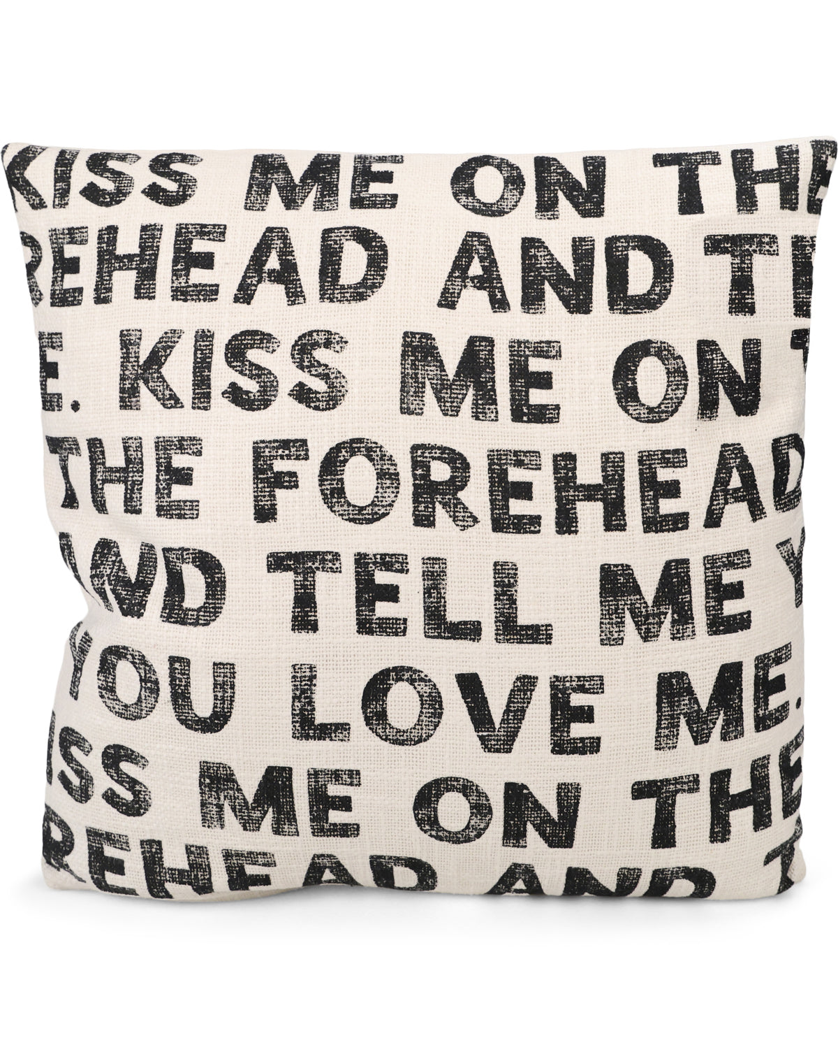 A square throw pillow in a textured cream fabric with black distressed text repeating the phrase 'KISS ME ON THE FOREHEAD AND TELL ME YOU LOVE ME'.