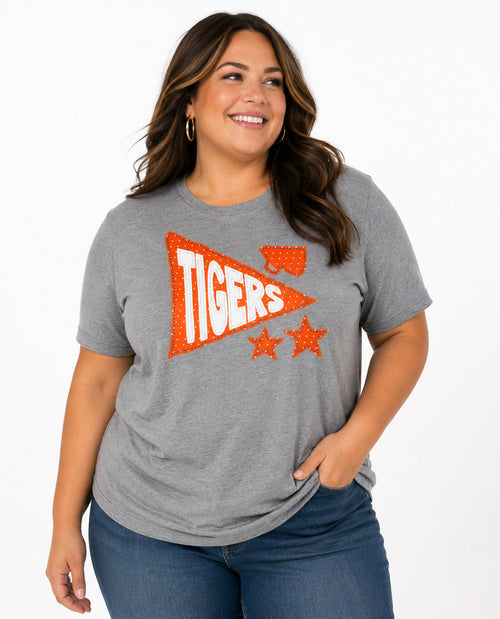 Woman wearing a gray t-shirt with 'Tigers' and star design on a white background