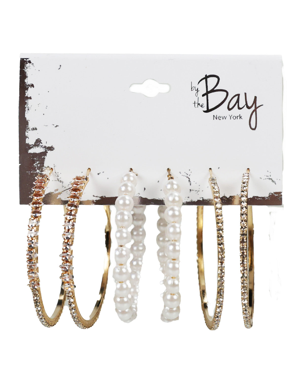 A 6-piece jewelry set by the Bay New York, featuring gold hoop earrings with clear rhinestones, rose gold hoop earrings with clear rhinestones, white faux-pearl beaded hoop earrings, and white faux-pearl beaded straight drop earrings, all displayed on a white branded card.