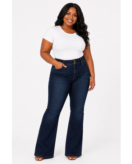 Woman wearing a white t-shirt and dark blue jeans on a white background