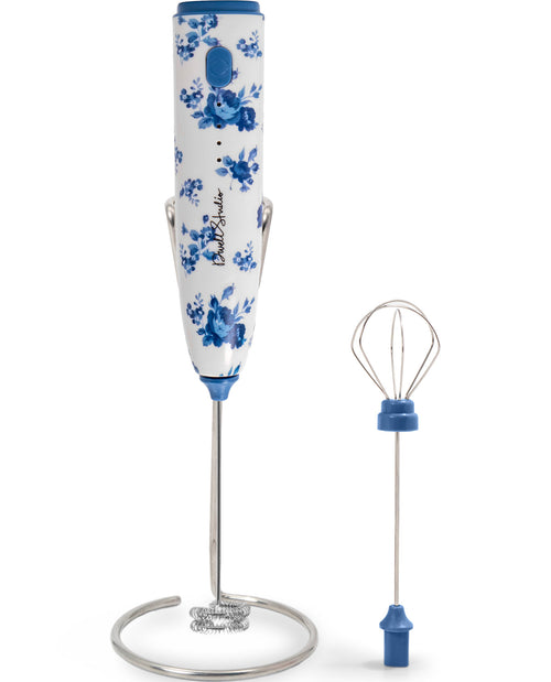Handheld blender with floral design on a white background