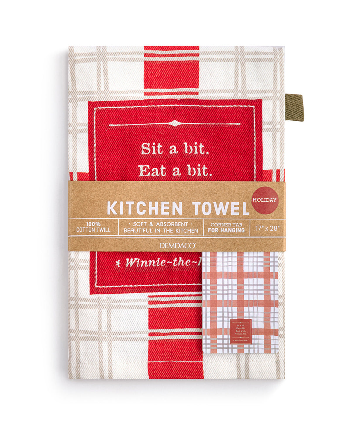 A packaged kitchen towel set by Demaco, featuring a red, white, and beige plaid pattern with a brown paper band label that reads 'KITCHEN TOWEL' and 'Holiday' in a red circle.