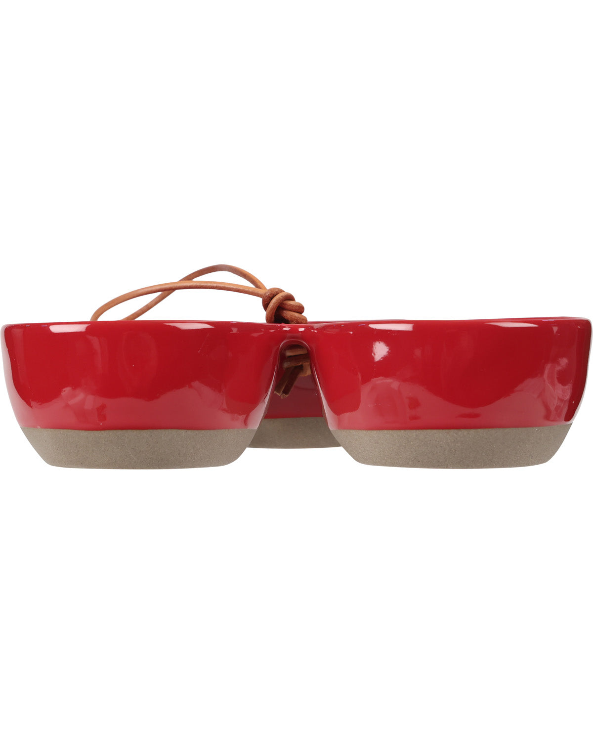 A pair of novelty sunglasses styled like a pair of safety goggles, featuring a glossy red upper half, a matte beige lower half, and a brown leather strap knotted at the top, shown against a plain white background.