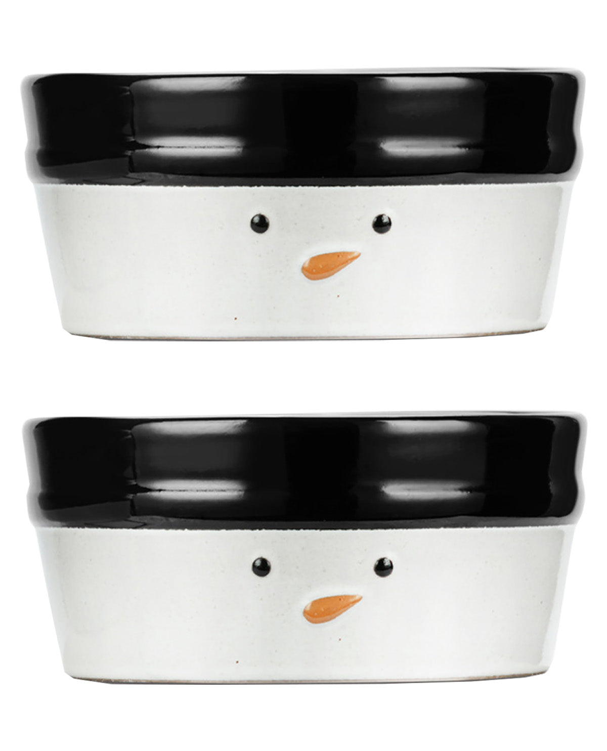 Two ceramic pet bowls stacked vertically on a white background. Each bowl is white on the outside with a glossy black rim, featuring a simple snowman face with black dot eyes and a small orange carrot nose.