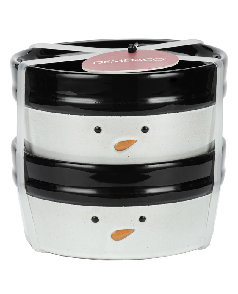 A stack of two ceramic snowman face containers or boxes by DEMPACO, featuring black and white bodies with small orange carrot noses and black eyes, wrapped in clear plastic.