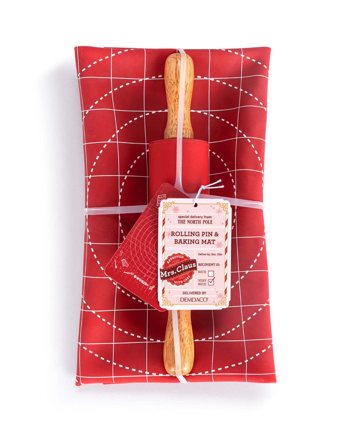A red rolling pin and matching red baking mat set wrapped in a red grid-patterned gift wrap, tied with a string and featuring a paper tag from Mrs. Claus's.