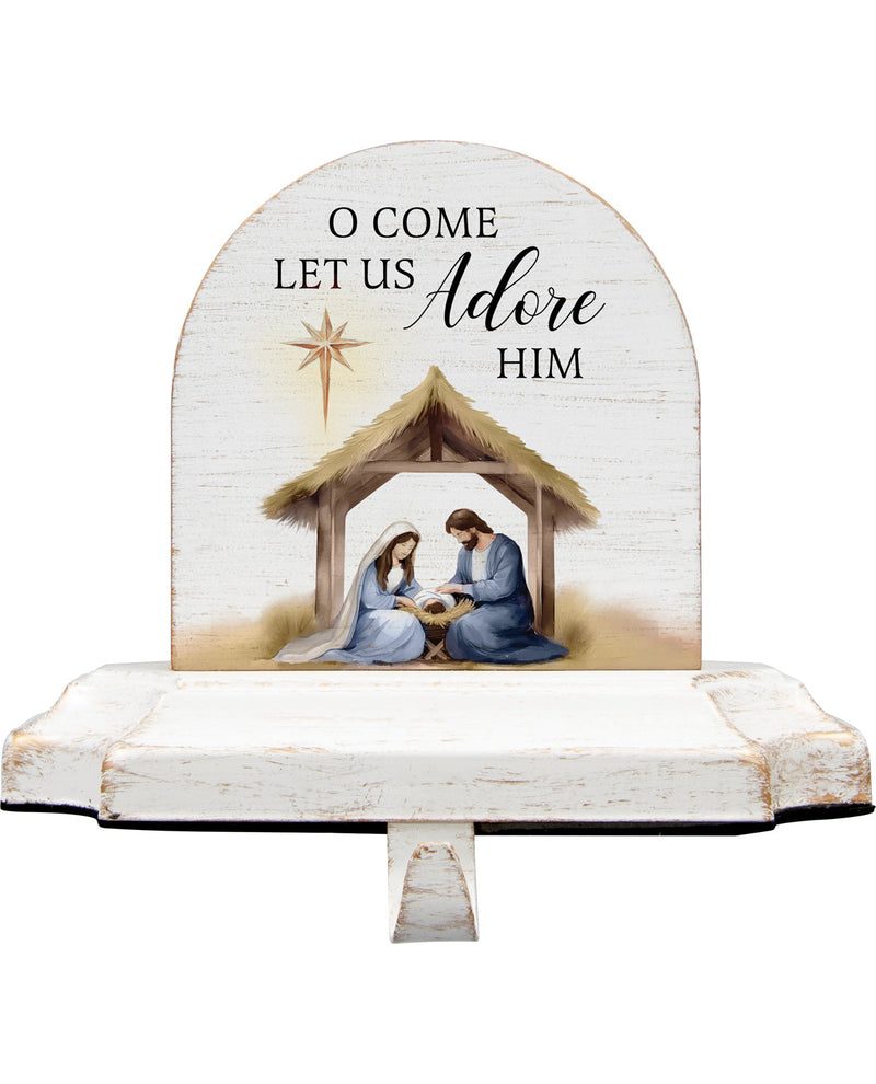 Decorative nativity scene with 'O Come Let Us Adore Him' text on a white background