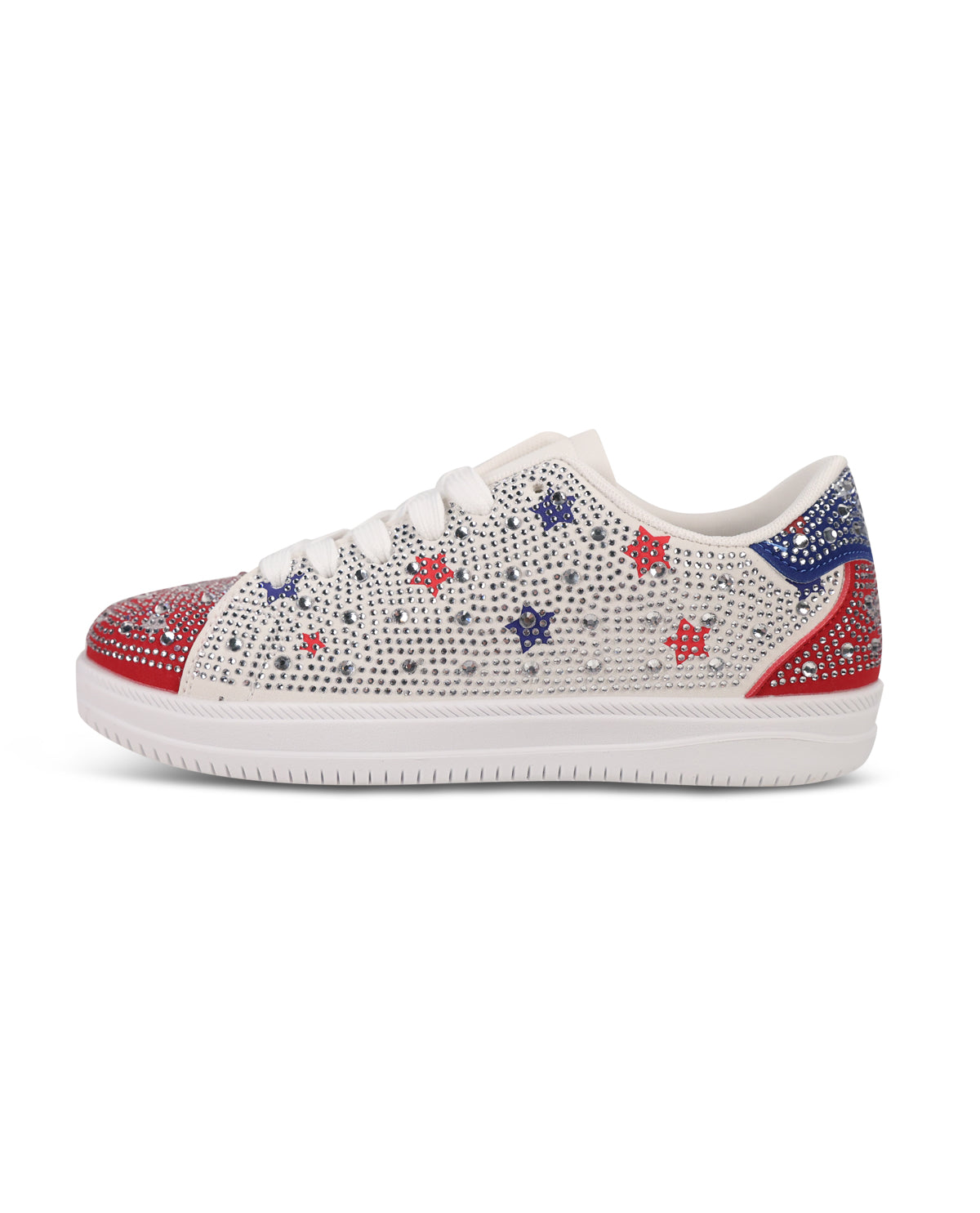 A low-top white sneaker embellished with sparkling rhinestones in red, white, and blue star patterns, featuring a red and blue rhinestone-embellished toe cap and heel tab, set against a plain white background.