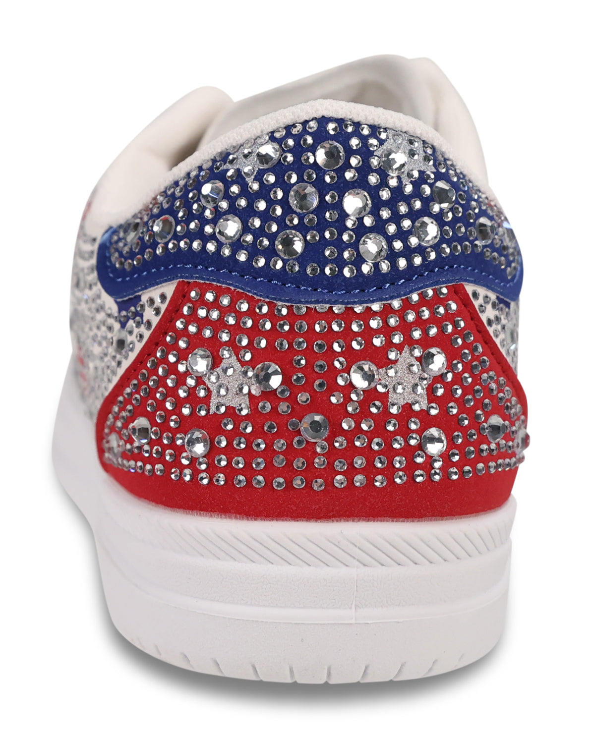 A close-up rear view of a low-top sneaker decorated with silver rhinestones. The shoe features a white base with a royal blue upper section and a red lower section, separated by a white stripe, on a white sole.