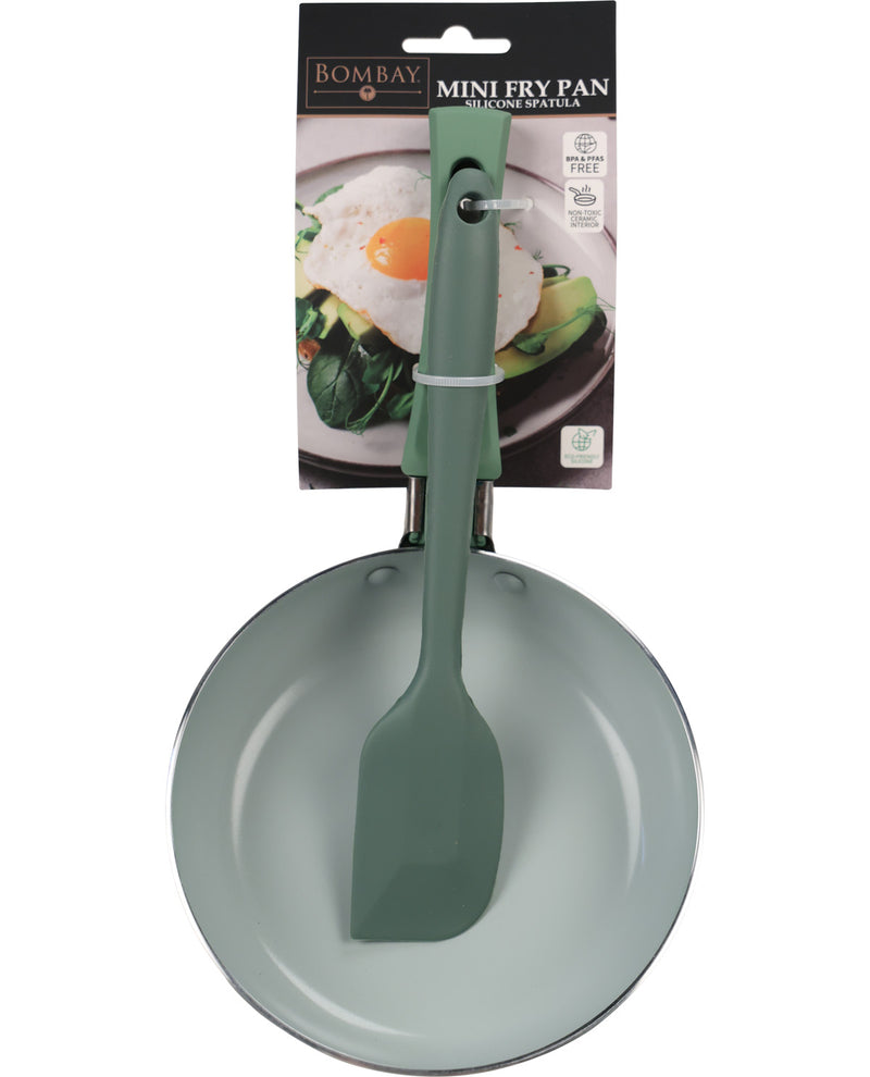 Bombay brand mini fry pan in sage green with a matching silicone spatula, shown in its original retail packaging against a white background.