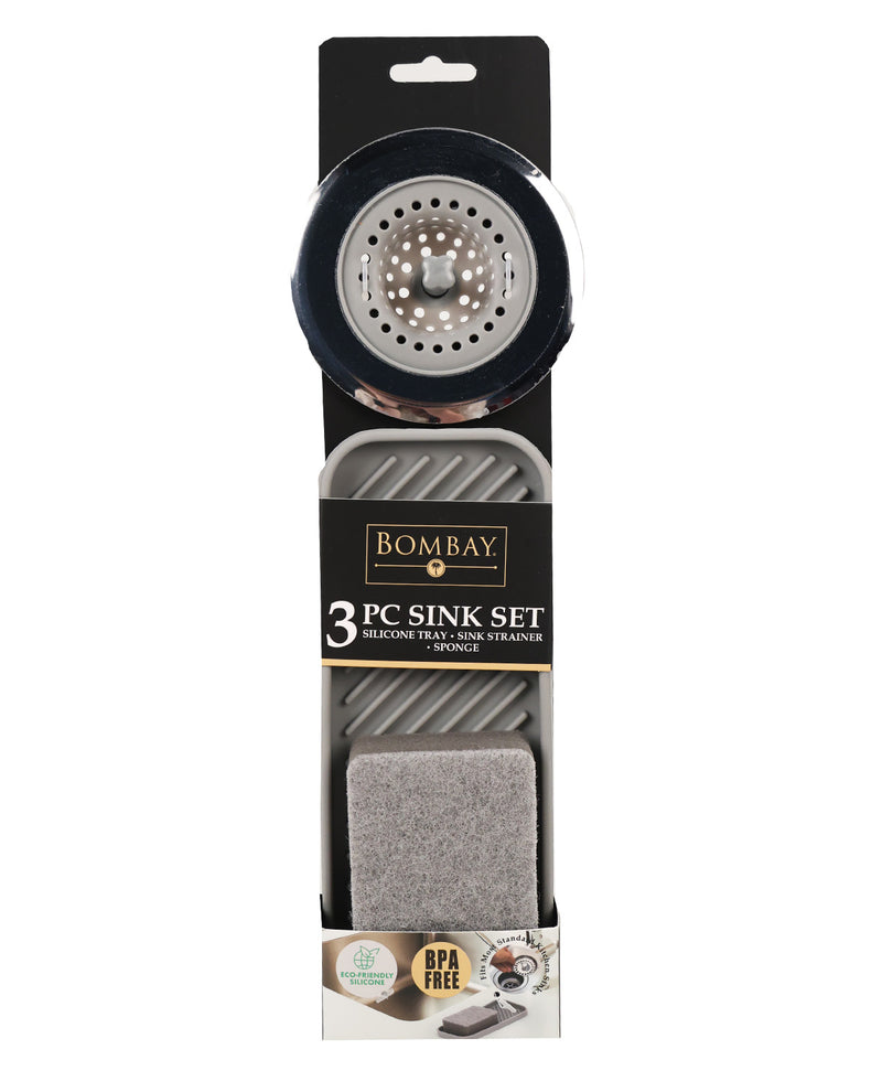 Bombay 3-piece sink set in its retail packaging, featuring a black and silver strainer basket, a gray sink mat, and a gray sponge block.