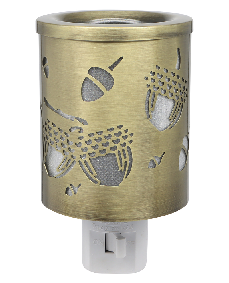 Brass-colored night light with acorn design on a white background