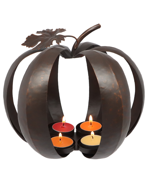 Decorative metal pumpkin candle holder with four lit candles on a white background