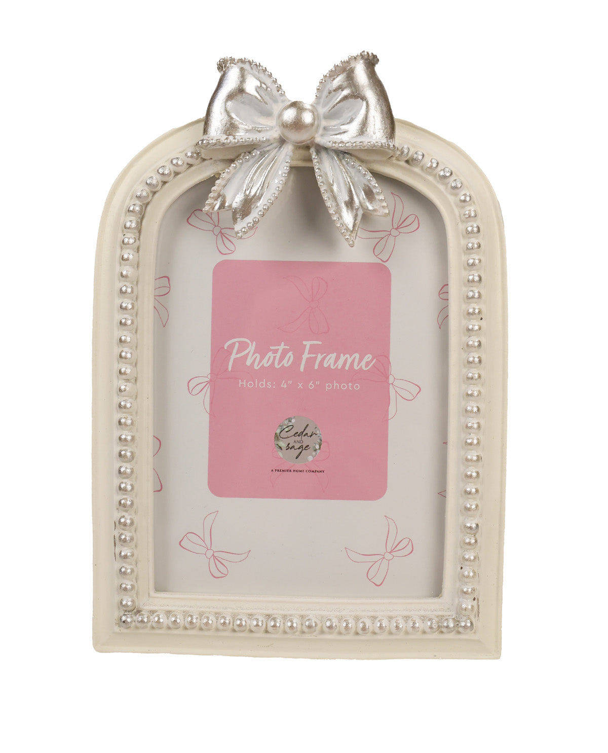An arched cream-colored picture frame with a decorative silver bow and pearl-like beaded border, shown holding a pink placeholder card.