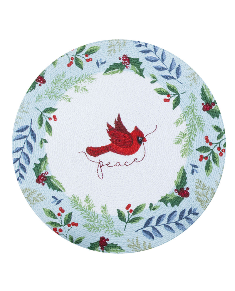Round placemat with a red cardinal and 'peace' text surrounded by greenery and berries on a light blue background.