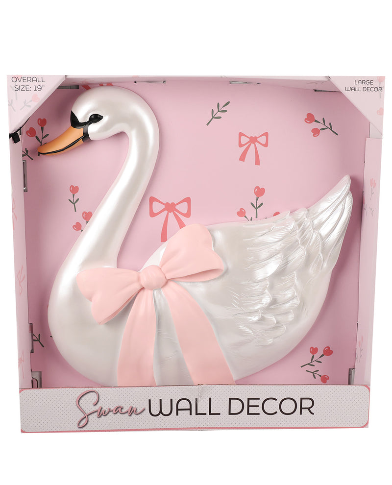 A white decorative swan wall decor piece with a light pink bow, displayed inside its pink retail packaging box.