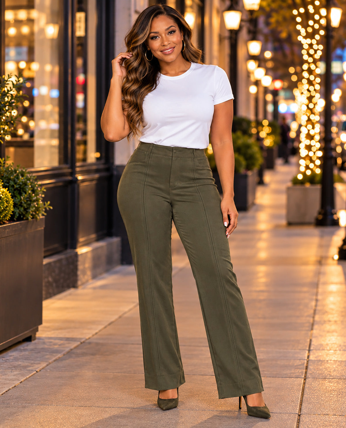 Missy model wearing olive suede pants with a white tee tucked in with a night scene background