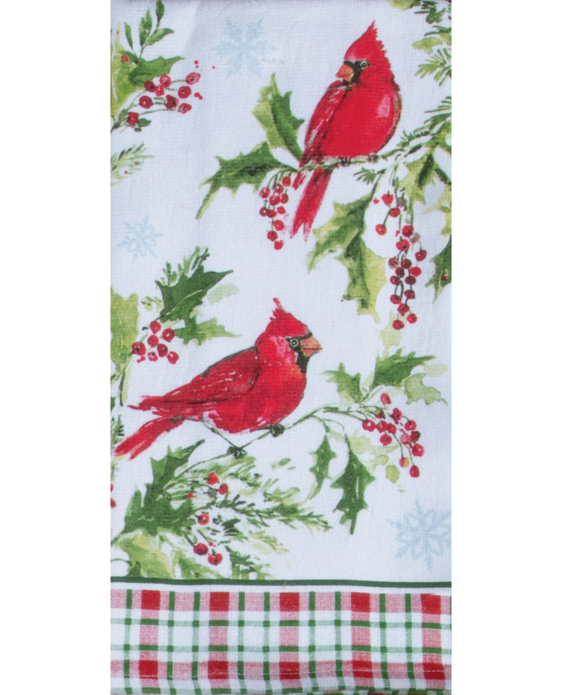 A white kitchen towel featuring a festive holiday print with two red cardinals perched on branches with green holly leaves and red berries, finished with a red, green, and white plaid border at the bottom.