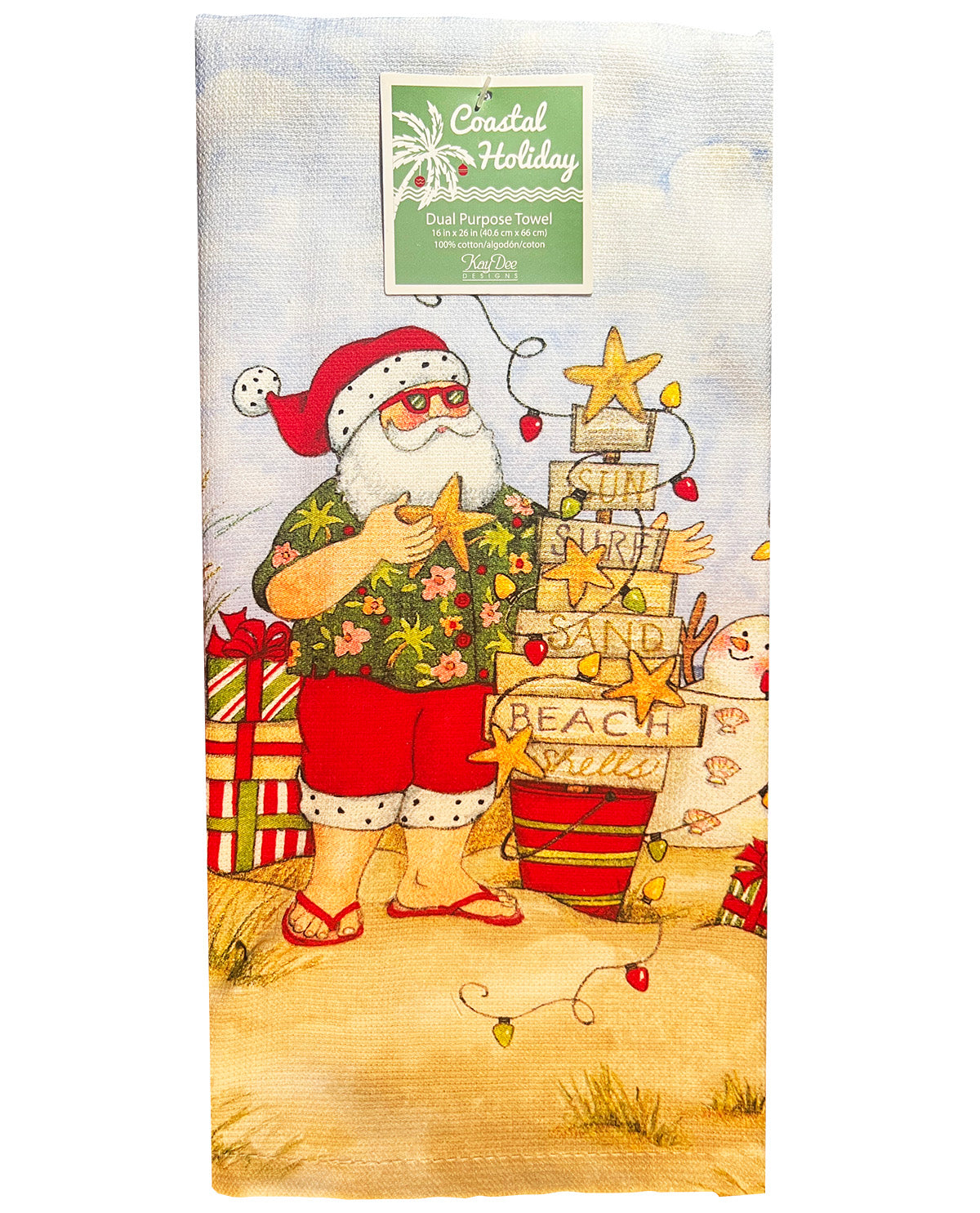 A Coastal Holidays 'Coastal Holiday' cotton pocket towel featuring a festive beach-themed illustration of Santa Claus in a Hawaiian shirt and red shorts, standing next to a decorated beach sign with stars and gifts.