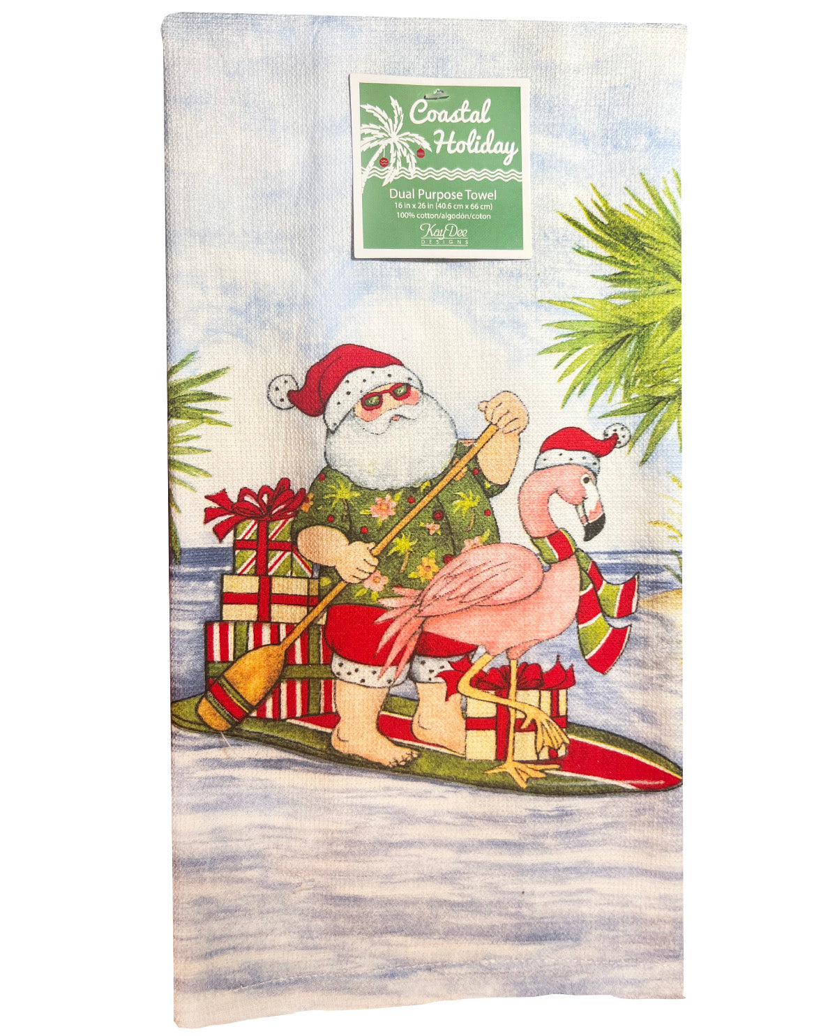 A Coastal Holidays dual purpose towel featuring a festive illustration of Santa Claus and a pink flamingo paddling in a canoe with wrapped gifts on the water, with a green brand label at the top.