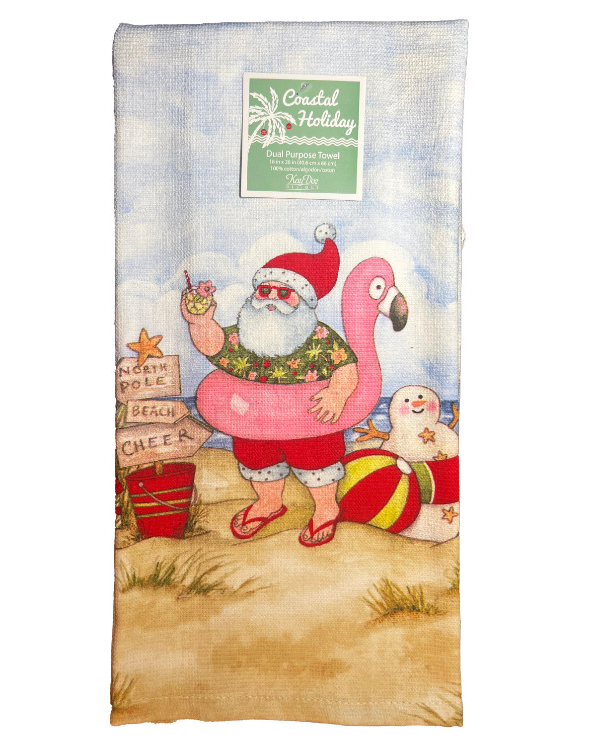 A rectangular beach towel featuring a festive Christmas beach scene. The illustration shows Santa Claus in a pink flamingo float, wearing a green tropical shirt and red hat, standing on a sandy beach next to a pink flamingo, a snowman, and a red beach bag.