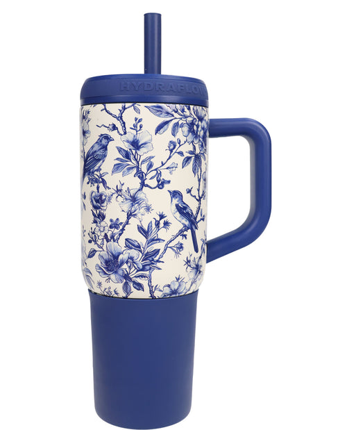 Blue and white floral-patterned mug with handle and straw on a white background