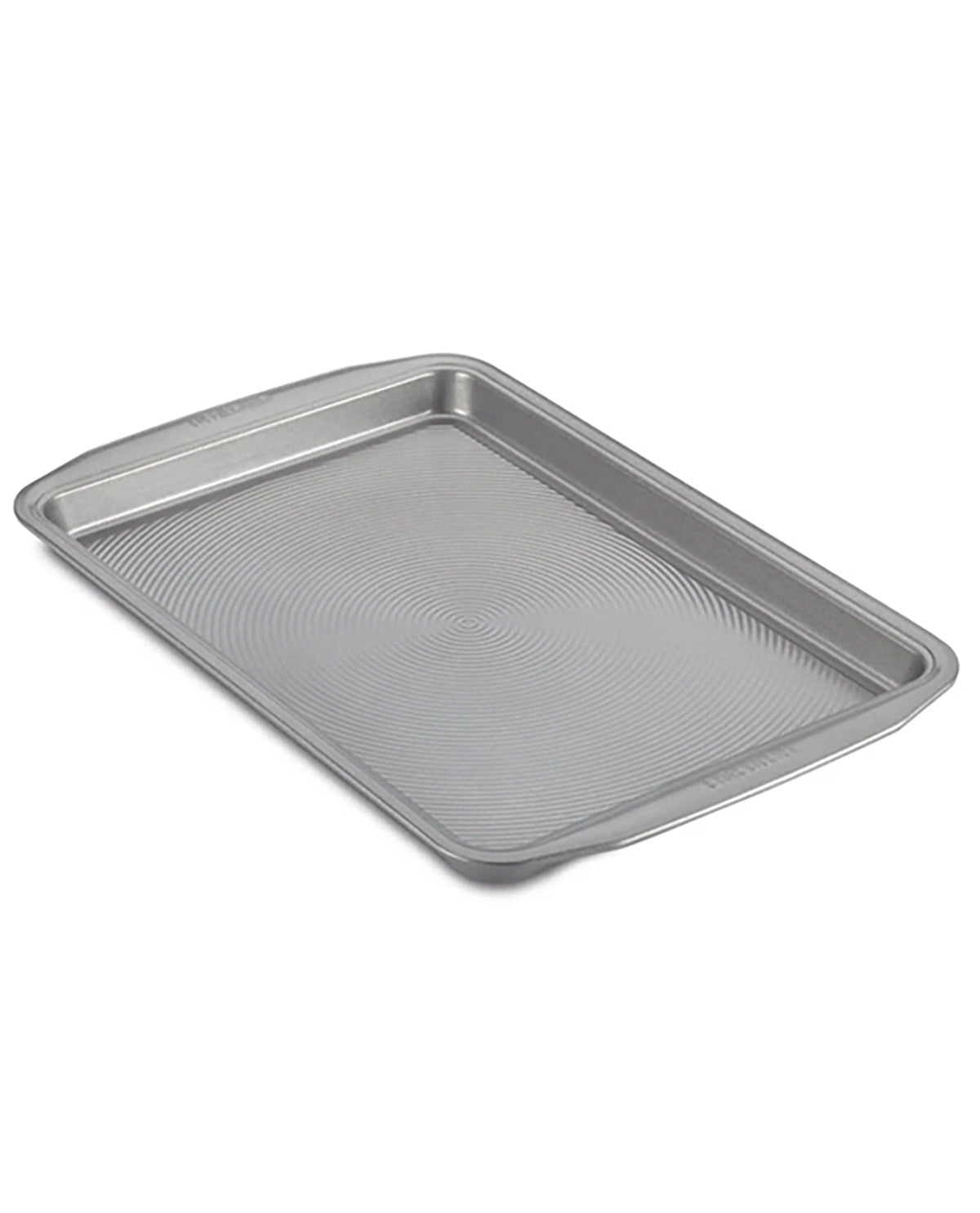 A rectangular metal baking pan with raised rim and a textured, ribbed interior surface, shown at an angle on a plain white background.