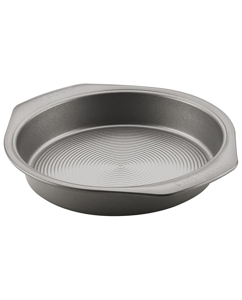 A round metal cake pan with a textured, ribbed interior and flared sides, shown on a plain white background.